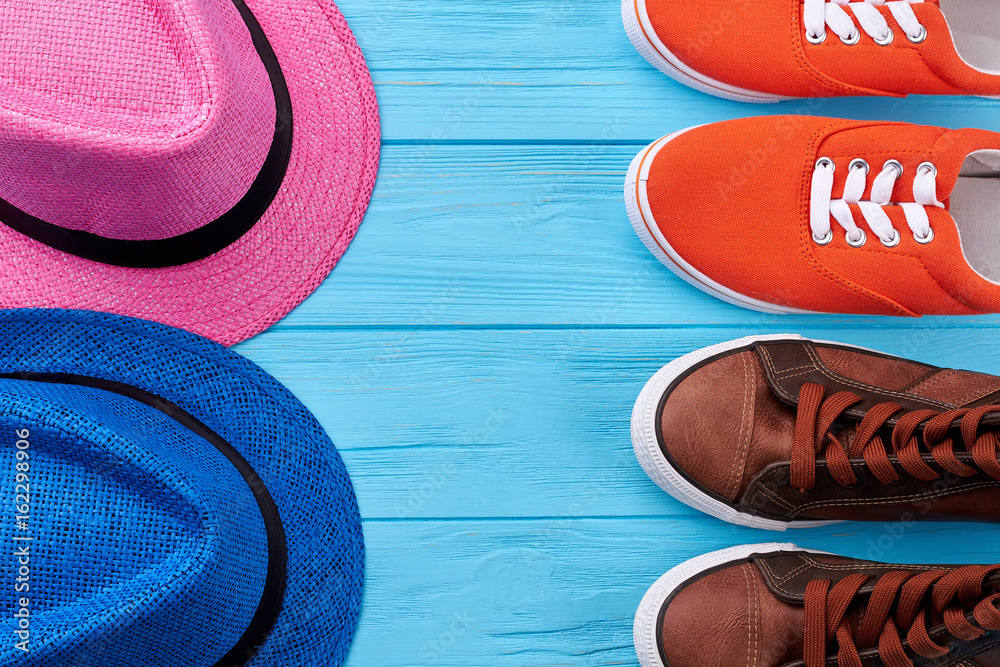 Pair of summer hats and shoes. Stylish sneakers for couple tourism.