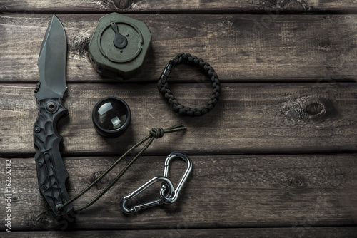 hiking travel gear on wood backdrop. Flat lay of outdoor travel equipment items for mountain camping trip..