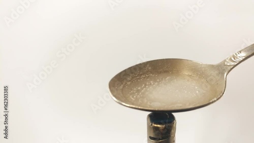 Man Preparing Dose Of cocaine by heating it with lighter in spoon.  Close up. Footage will work great for any videos dealing with opiate addiction, Life Danger, crime.