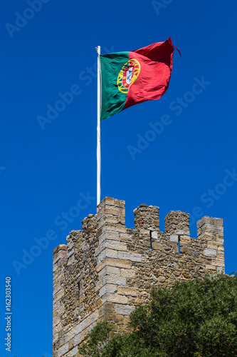 Guard castle tower Castelo de S. Jorge with the Portuguese flag, Lisbon