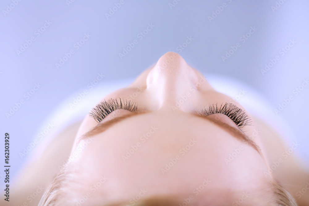 Young woman lying on a massage table,relaxing with eyes closed. Woman. Spa salon Young woman lying on a massage table,relaxing with eyes closed. Woman. Spa salon