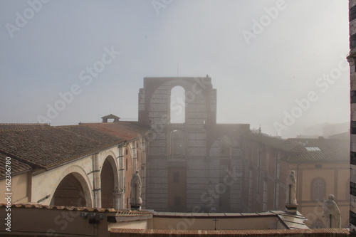 Incomplete facade of the planned Duomo nuovo or Facciatone in fog. Siena. Tuscany Italy.