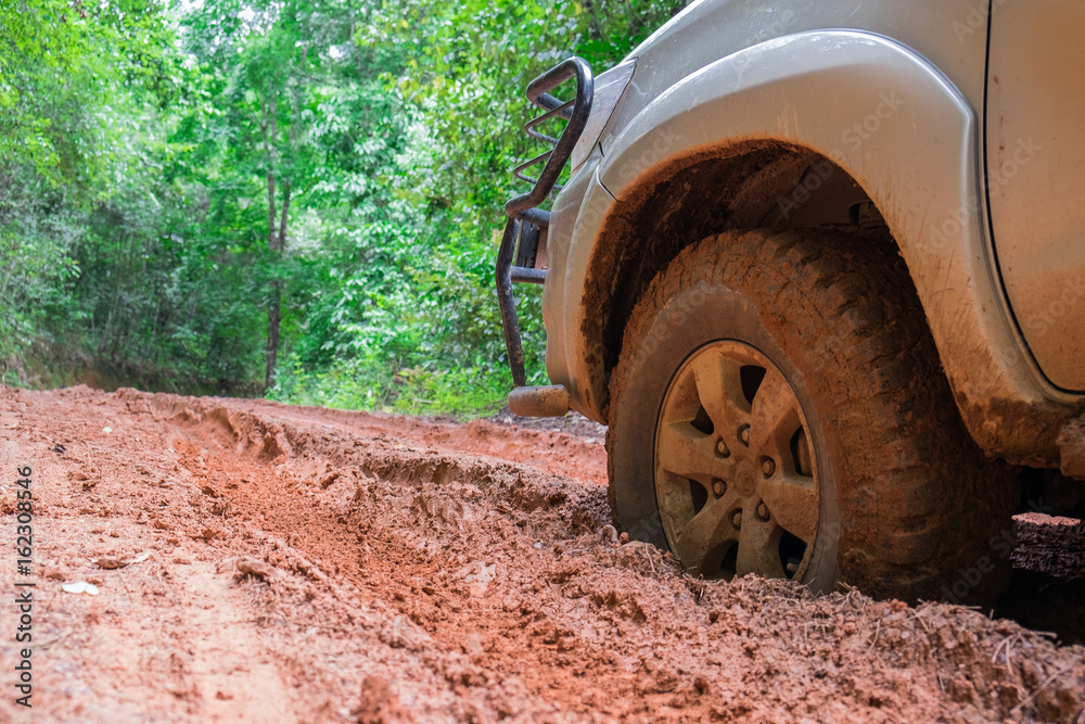 Wheel closeup in a countryside landscape with a muddy road Wheel closeup in a countryside landscape with a muddy road