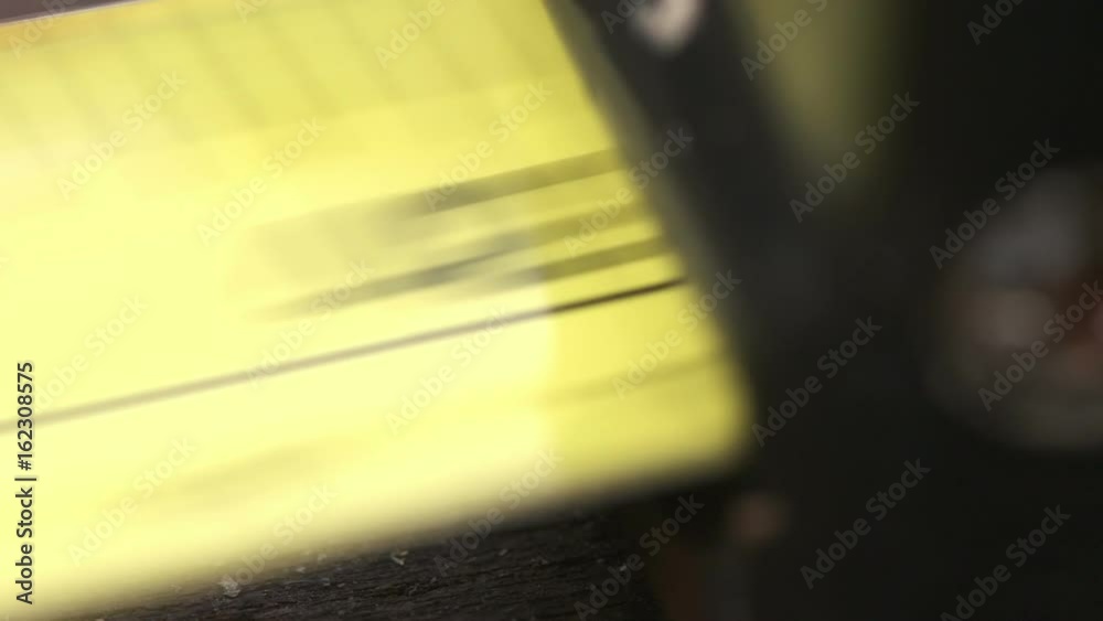 Super closeup of a tape measure recoiling back in after measurement was taken Super closeup of a tape measure recoiling back in after measurement was taken