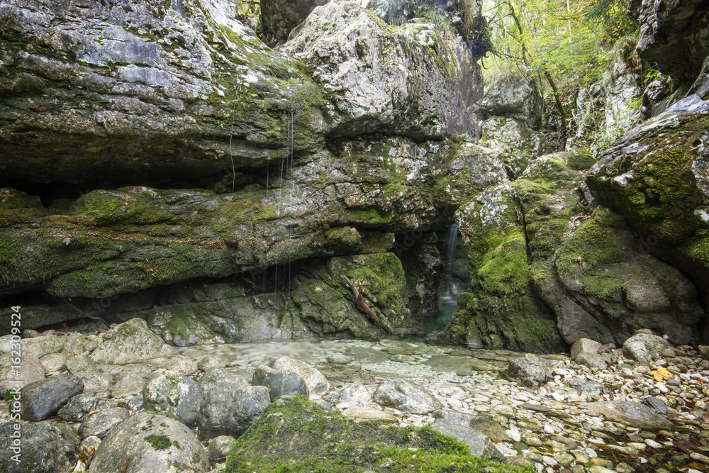 Small creek making tiny waterfalls dripping from rocks Small creek making tiny waterfalls dripping from rocks