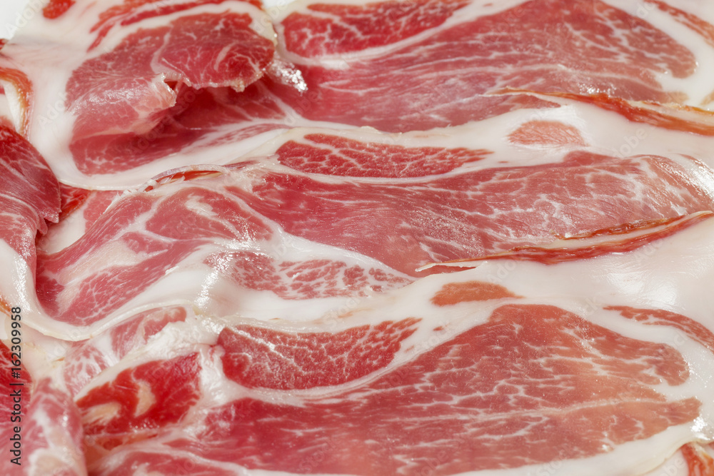 Classic spanish tapas: sliced ham served on a dish. Spanish name Jamon Iberico. Classic spanish tapas: sliced ham served on a dish. Spanish name Jamon Iberico.