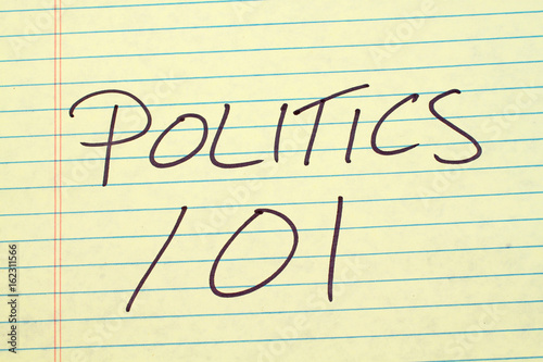 The words "Politics 101" on a yellow legal pad