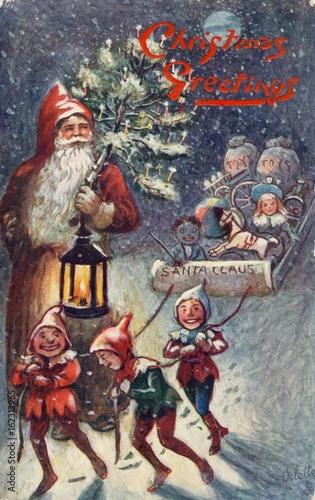 Obraz na plátně Father Christmas and elves pulling sleigh. Date: 1908