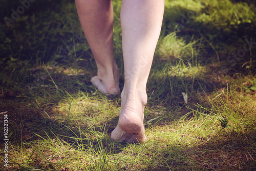 Female barefoot legs walking in nature