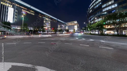 Time lapse of long exposure of car light trail and illuminated building, urban scene

