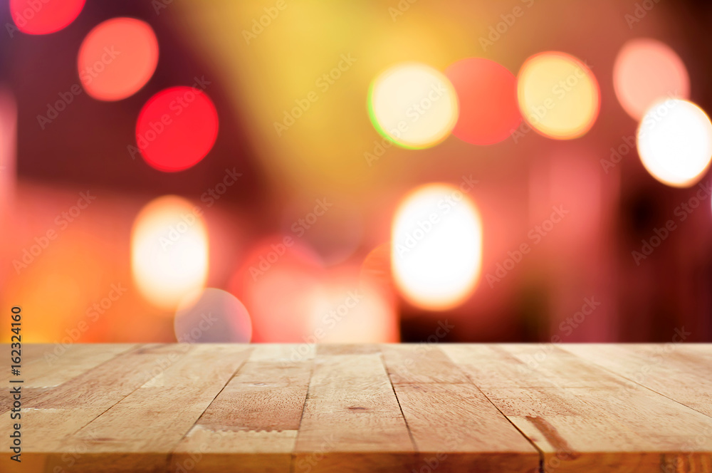 Wood table top on abstract colorful bokeh background at night