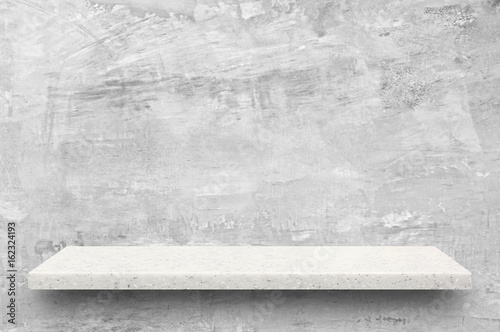 White stone shelf on bare concrete wall background © Atstock Productions