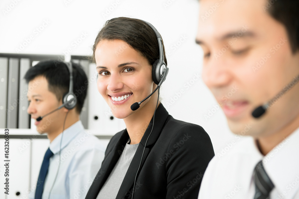 Smiling businesswoman working in call center as a telemarketer Smiling businesswoman working in call center as a telemarketer