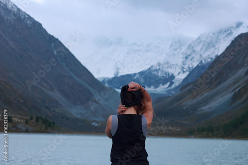 Young girl in the background of a mountain lake