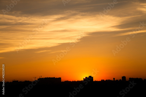 Sunset in the city beyond the horizon from the height