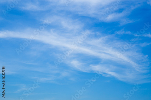 Bright sky with floating clouds