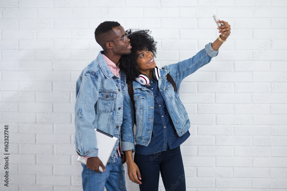 Portrait of young African American couple in love posing together indoors Portrait of young African American couple in love posing together indoors
