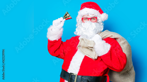 Funny Santa Claus have a fun with bell