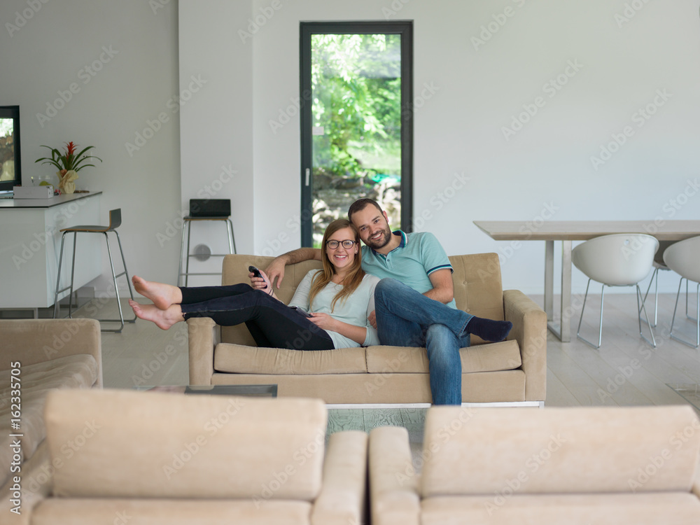 Young couple on the sofa watching television