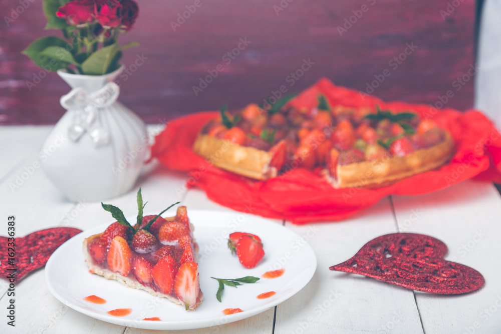 Strawberry pie on whire plate and white wooden table. One piece. Romantic. Love. Heart.