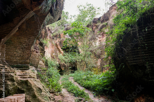 The exploitation of limestone hills canyon forming a unique architectural in Arosbaya Hill Madura Island, Indonesia photo