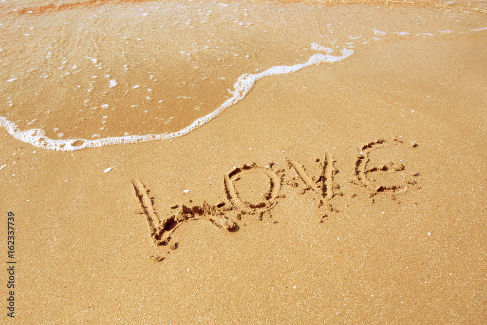 Love inscribed in the sand of a beach Love inscribed in the sand of a beach