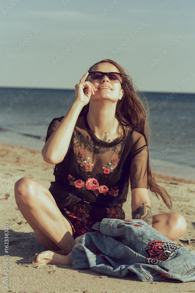 Attractive young woman on ocean beach at sunset Attractive young woman on ocean beach at sunset
