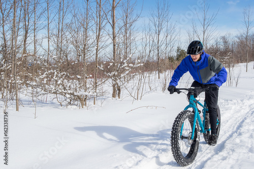 Man riding his fat bike in the snow