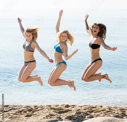 Three girls jumping on beach © JackF
