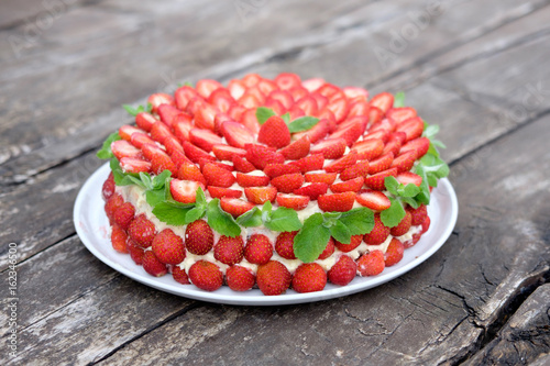 strawberry cake on wooden surface