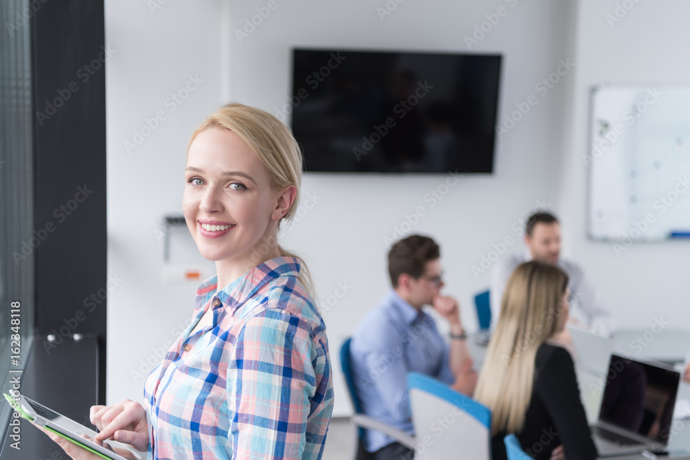 Pretty Businesswoman Using Tablet In Office Building by window Pretty Businesswoman Using Tablet In Office Building by window