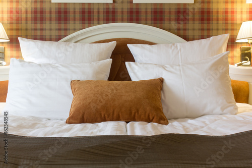 Pillows on bed in hotel roo...