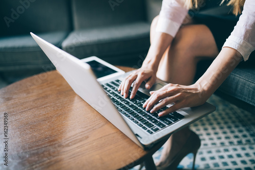 Close-up picture of female hands typing on laptop