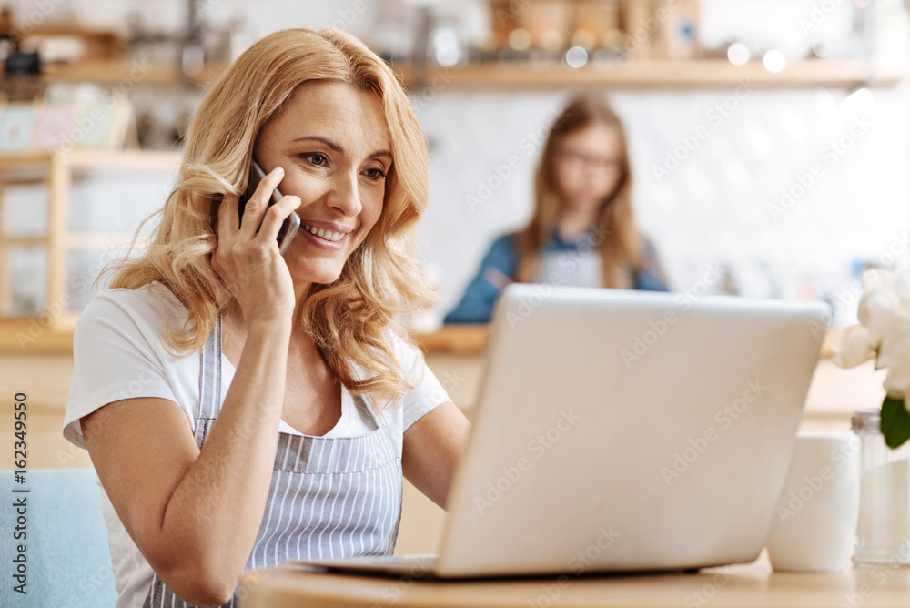 Charming woman receiving good news on the phone Charming woman receiving good news on the phone