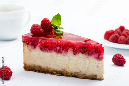 Raspberry cheesecake on white background.