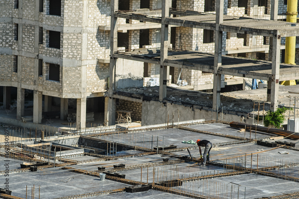 Fototapeta premium Construction worker working hard on a construction site.