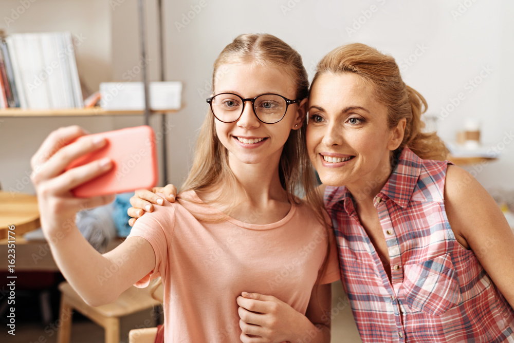 Sweet mother and daughter posing for a selfie Stock Photo Adobe Stock