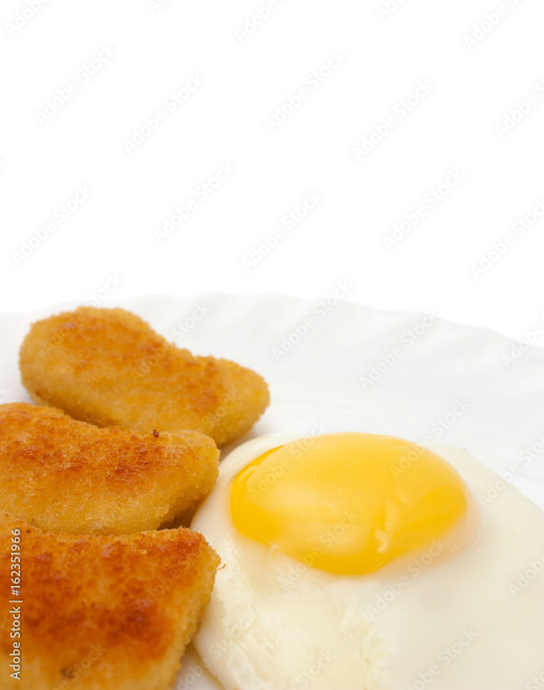 Fried egg and nuggets on plate copy space Fried egg and nuggets on plate copy space