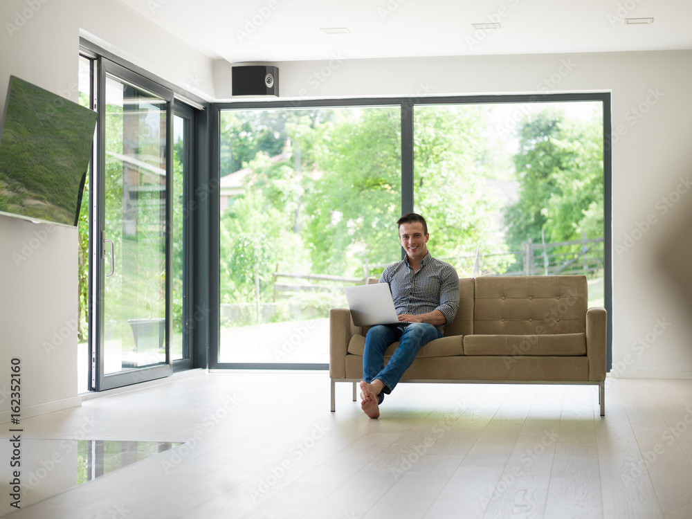 Man using laptop in living room