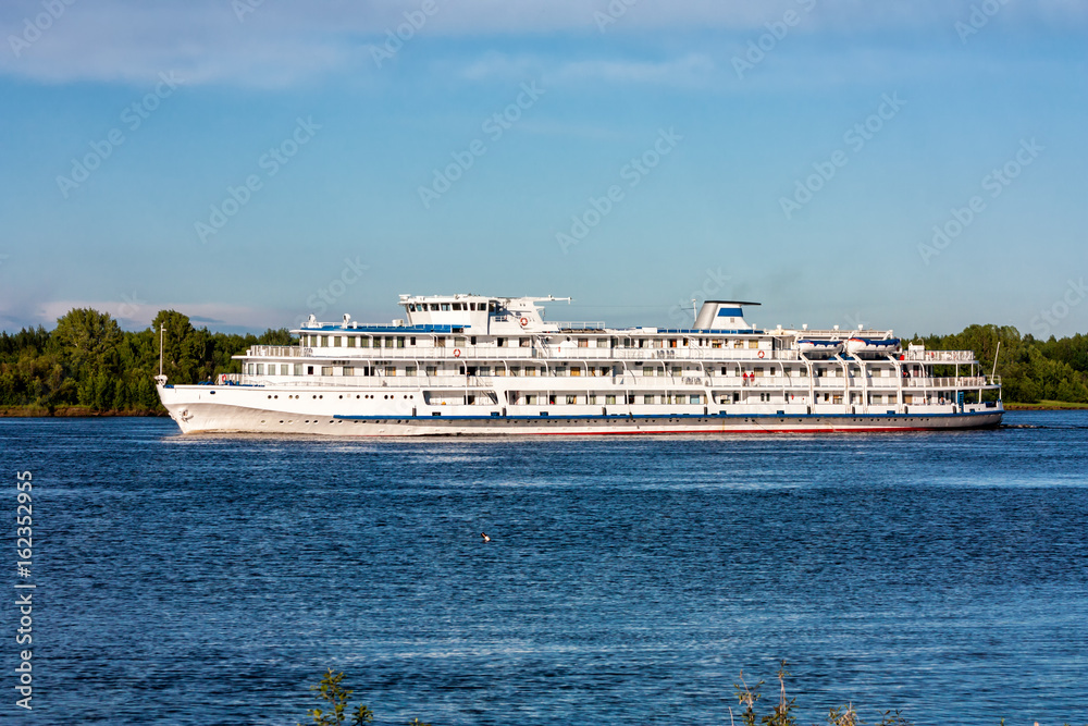 Passenger cruise ship sails on the river Passenger cruise ship sails on the river