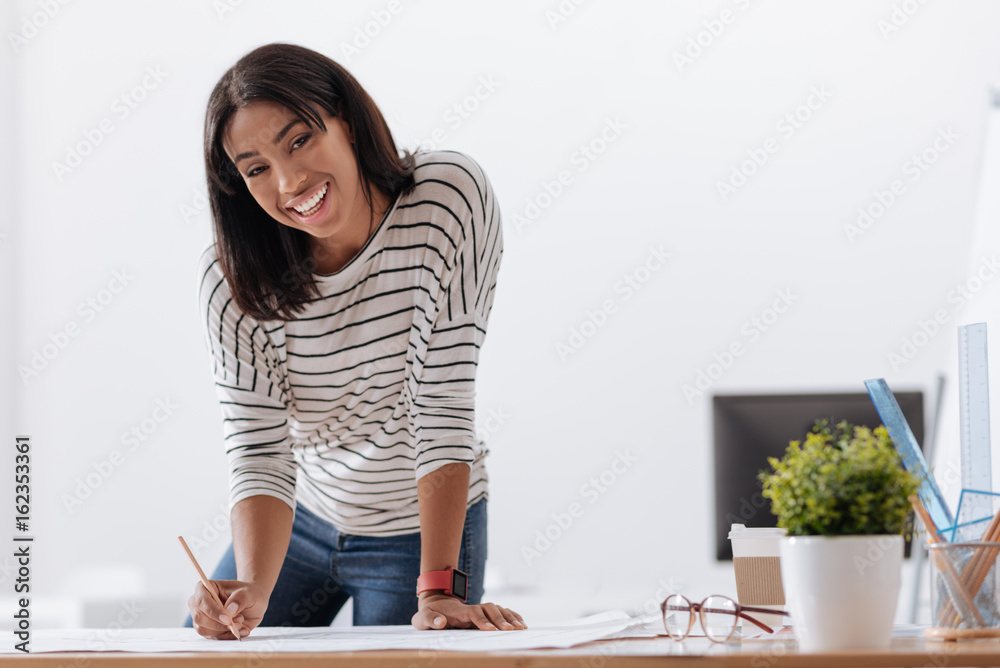 Joyful positive woman working on a project Joyful positive woman working on a project