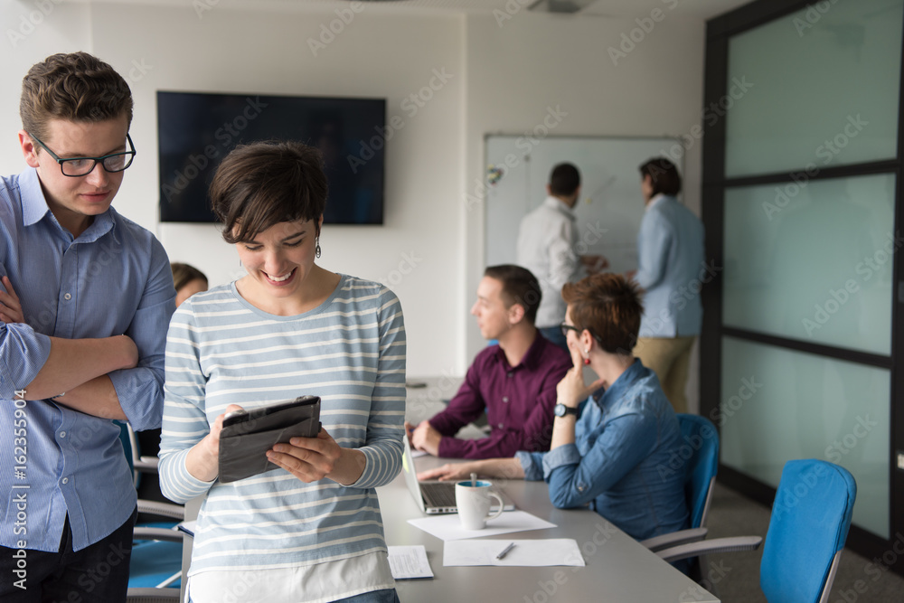 Two Business People Working With Tablet in office Two Business People Working With Tablet in office