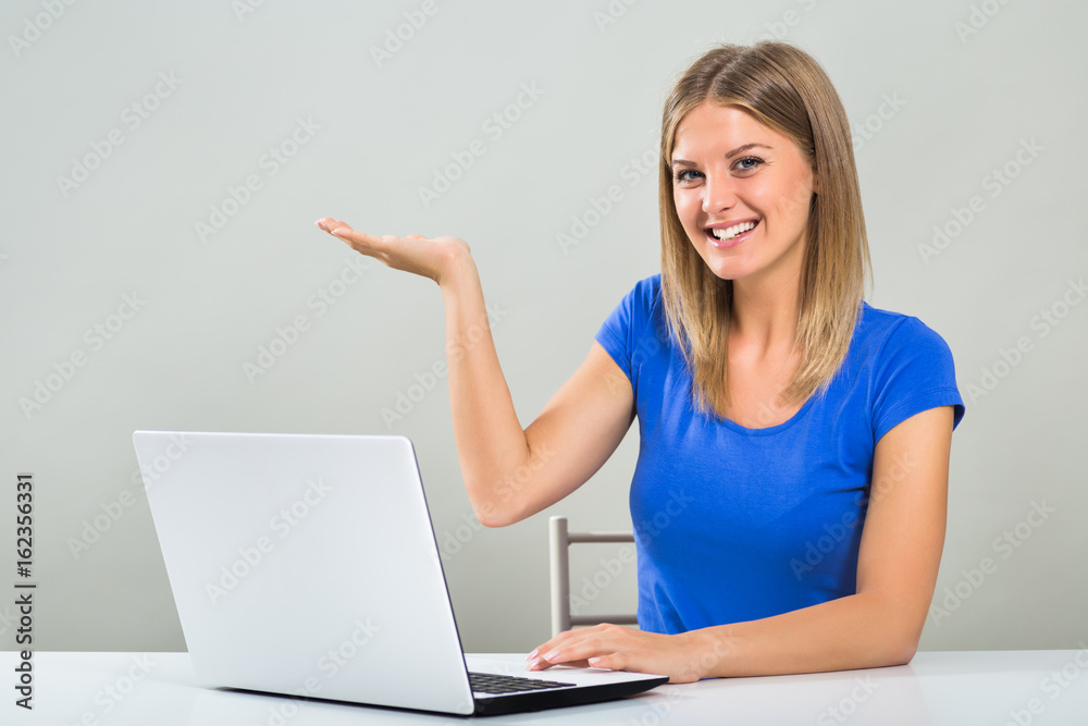 Beautiful young woman is gesturing while using laptop. Beautiful young woman is gesturing while using laptop.