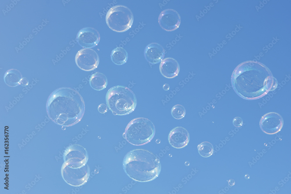 Soap bubbles on blue sky background