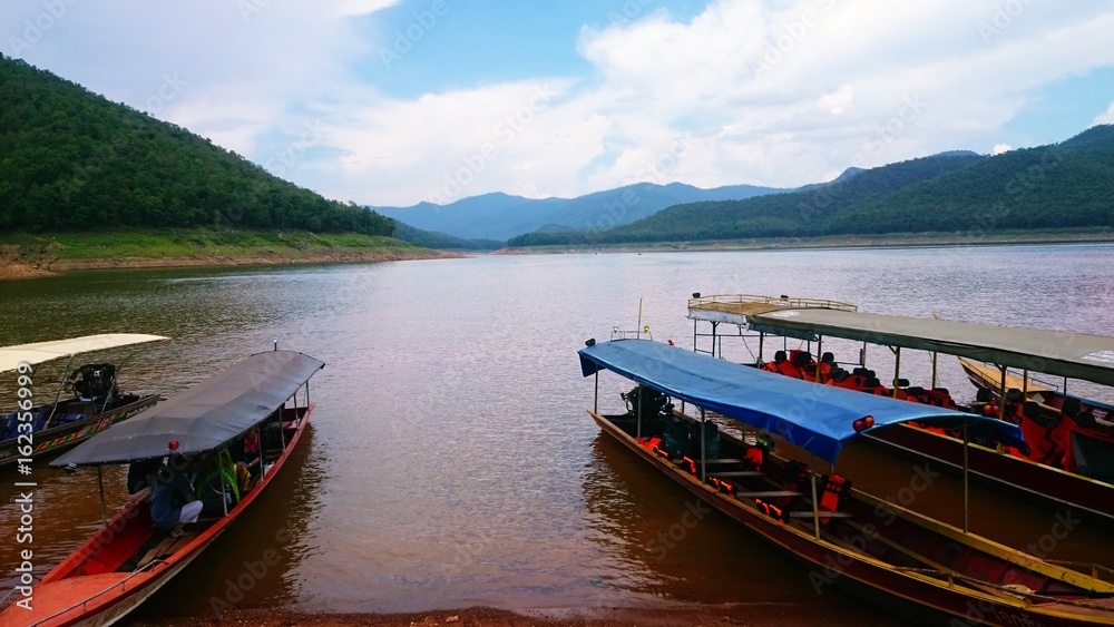 At the water transport, there are waiting passenger boats in the river.