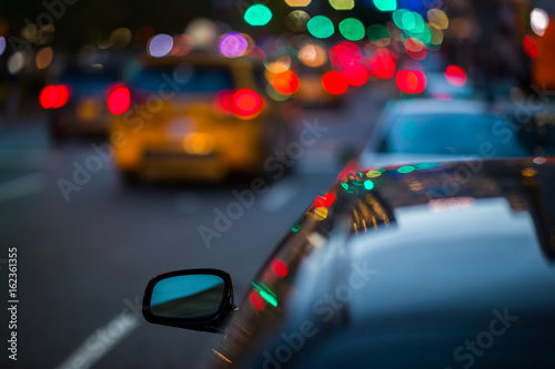 Wing mirror of a car in busy city traffic
