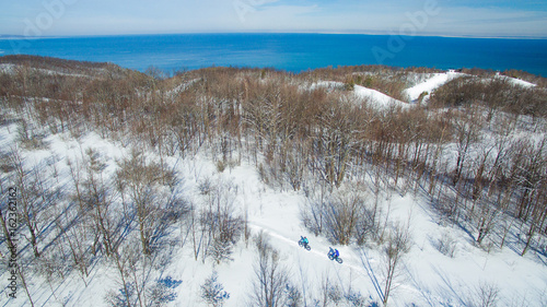 Wallpaper Mural Aerial photo of a couple riding fat bikes in the snow Torontodigital.ca