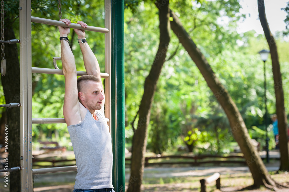 street workout man exercise in a park