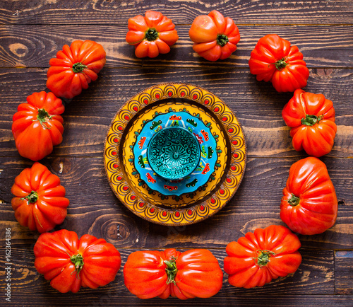 Ox heart tomatoes, on rustic wood background, free space for text.