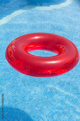 Flotador rojo de playa sobre piscina con fondo azul claro. Stock Photo |  Adobe Stock